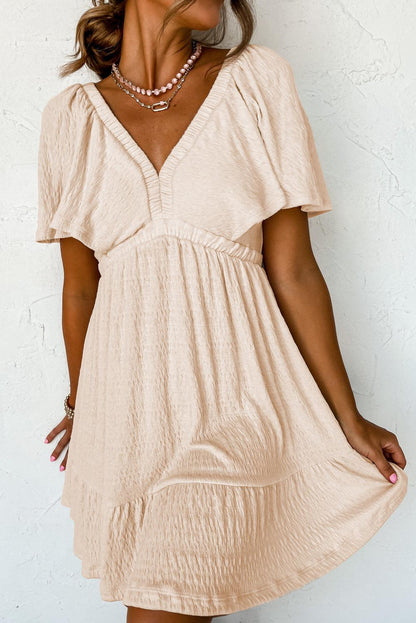 LM | Textured beige mini dress with deep V-neck for stylish women