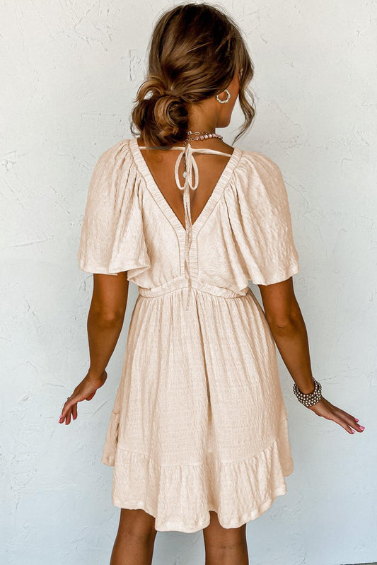 LM | Textured beige mini dress with deep V-neck for stylish women